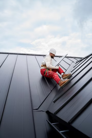 full-shot-man-with-helmet-sitting-roof_23-2149343664